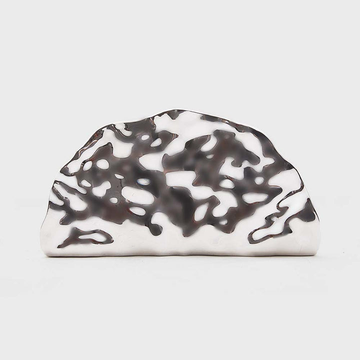 sculpted metallic clutch with abstract cutout design – NOIRÉP