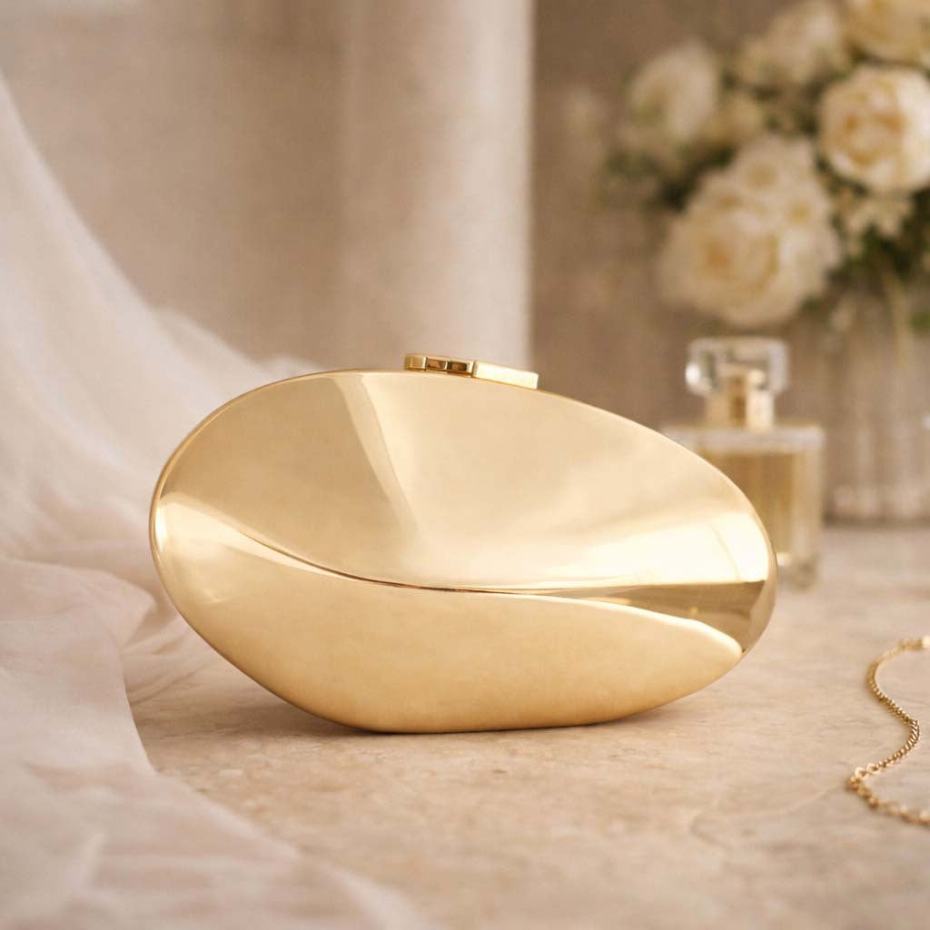 Oval metallic clutch with smooth sculpted design – CURVE
