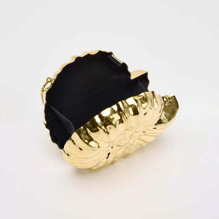 Round sculpted gold clutch with organic texture – BLOOM