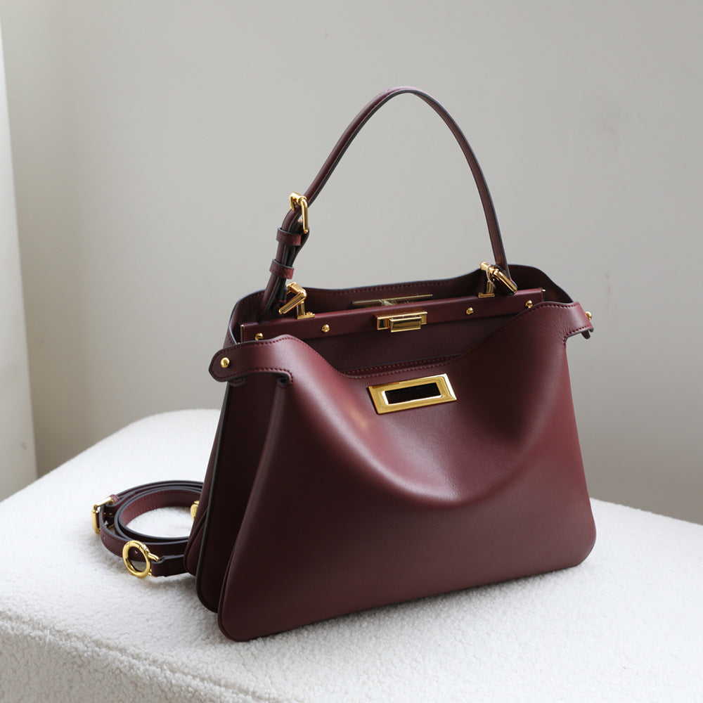 structured leather top-handle bag with gold hardware – ARIEL