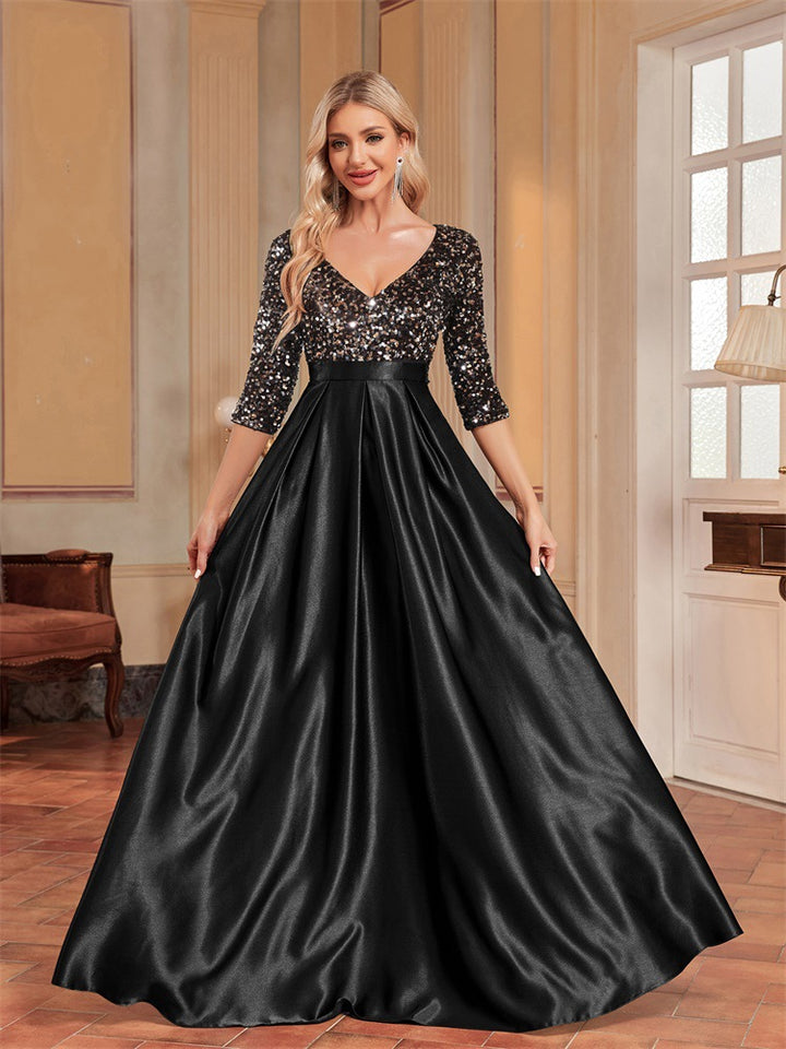 فستان من الترتر بفتحة رقبة على شكل حرف V وتنورة من الساتان على شكل حرف A – إيسمي